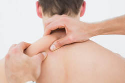 man receiving deep tissue shoulder massage